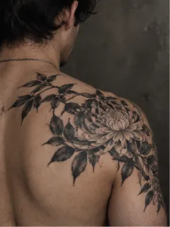 Black and grey chrysanthemum flower shoulder and back tattoo