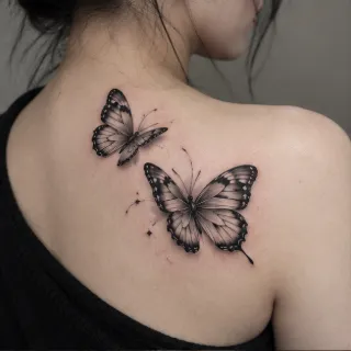 Two realistic black and grey butterfly shoulder blade tattoo