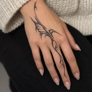 Abstract fine line tribal style hand and finger tattoo