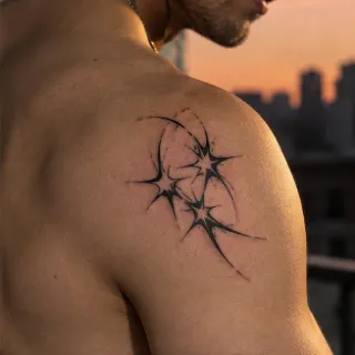 Blackwork starburst and abstract line shoulder tattoo