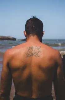 Try fail repeat script lettering upper back tattoo