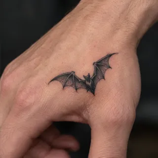 Small realistic bat hand tattoo