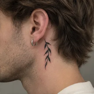 Minimalist blackwork leaf branch behind the ear tattoo
