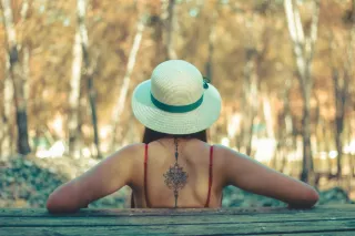 Ornamental mandala style spine tattoo