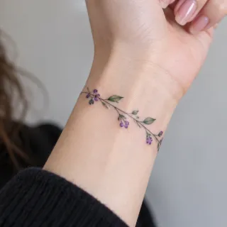Fine line botanical vine and berry wrist bracelet tattoo