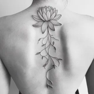 Fine line lotus flower with trailing vines back tattoo