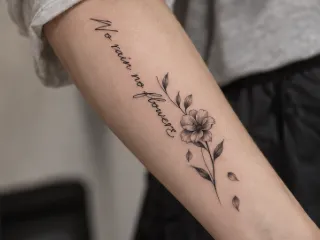 Fine line flower and quote forearm tattoo