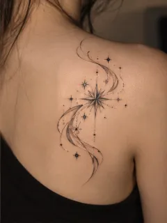 Fine line north star and swirling cosmic dust shoulder tattoo