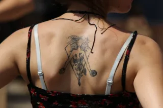 Fine line female figure and floral back tattoo