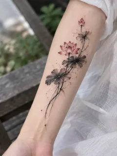 Watercolor lotus flower and leaves forearm tattoo