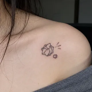 Minimalist fine line crumpled paper ball collarbone tattoo