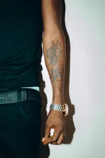 Dice and star traditional style forearm tattoo