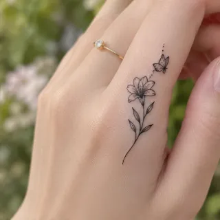 Fine line flower and butterfly finger tattoo