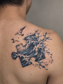 Realism ocean wave puzzle piece and birds shoulder tattoo
