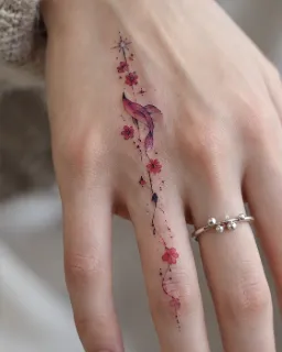 Fine line whale and flower hand tattoo
