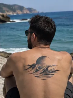 Blackwork ocean waves and moon back tattoo