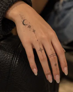 Fine line celestial moon and stars hand and finger tattoo