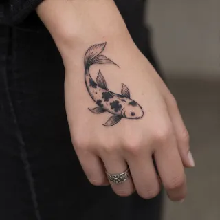 Fine line koi fish hand tattoo