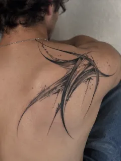 Abstract blackwork flowing lines shoulder blade tattoo