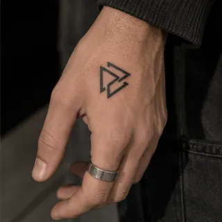 Minimalist geometric triangle symbol hand tattoo