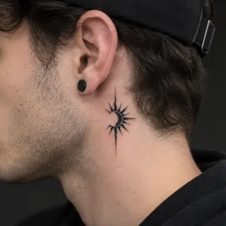 Blackwork sun and crescent moon neck tattoo