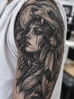 Realism wolf headdress and woman portrait upper arm tattoo