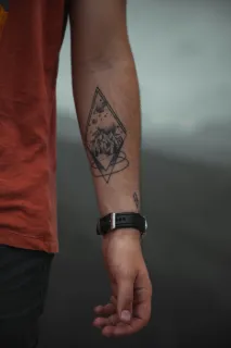 Geometric mountain and space landscape forearm tattoo