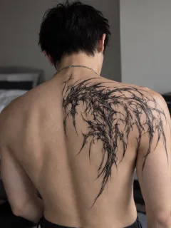 Abstract blackwork dragon shoulder and back tattoo