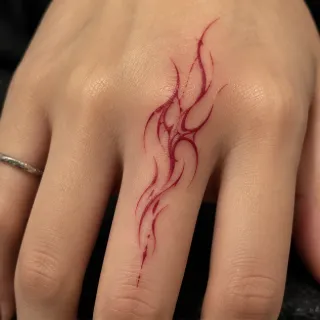Red fine line abstract tribal finger tattoo