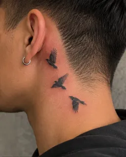 Small blackwork flying birds neck tattoo