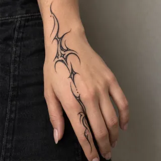 Abstract fine line tribal style hand tattoo