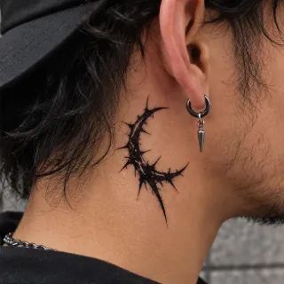 Blackwork thorny crescent moon neck tattoo
