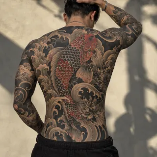 Japanese koi fish and lotus flower full back tattoo