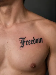 Freedom lettering in gothic script chest tattoo