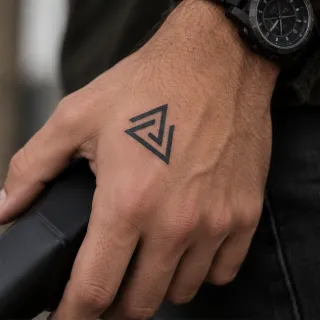 Minimalist geometric triangle hand tattoo