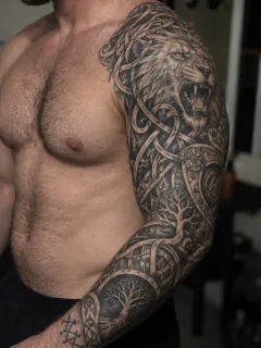 Black and grey lion and norse knotwork sleeve tattoo