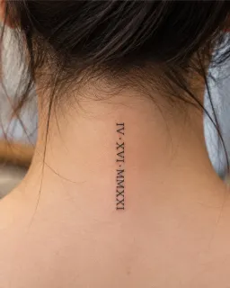 Minimalist roman numeral date fine line back of neck tattoo