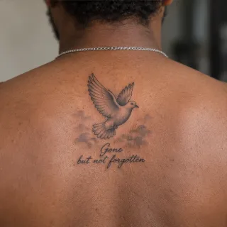 Flying dove and clouds memorial back tattoo
