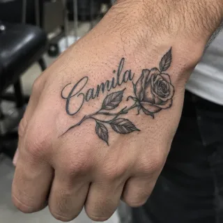 Script name and rose fine line hand tattoo