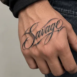 Savage script lettering hand tattoo
