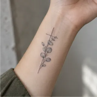Fine line cross and eucalyptus branch forearm tattoo