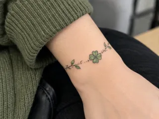 Fine line four leaf clover bracelet wrist tattoo