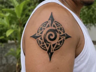 Tribal compass and spiral shoulder tattoo